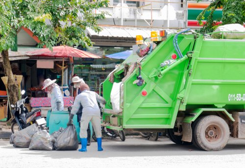Segregated hazardous waste containers and labelled bins awaiting collection